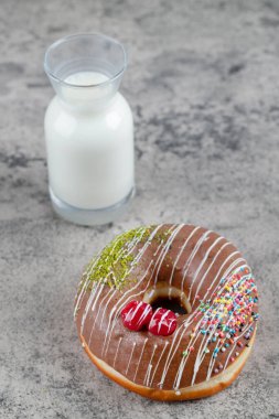 Çikolatalı çörek ve taş yüzeyde bir bardak taze sütle süslenmiş. Yüksek kalite fotoğraf