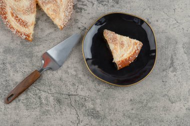 Taş zeminde siyah bir tabak lezzetli vanilyalı kek. Yüksek kalite fotoğraf