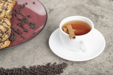 Kırmızı tabak tatlı bisküvi ve bir fincan siyah çay. Yüksek kalite fotoğraf