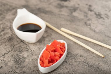 Wasabi with soy sauce and ginger placed on a stone table. High quality photo