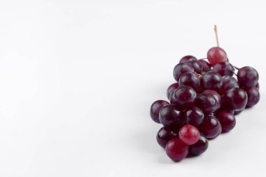 Cluster of fresh red grapes isolated on white background. High quality photo