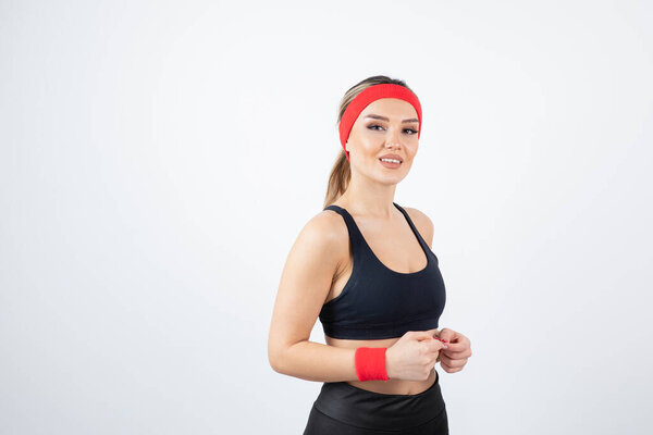 Portrait of young athletic woman wearing red headband. High quality photo