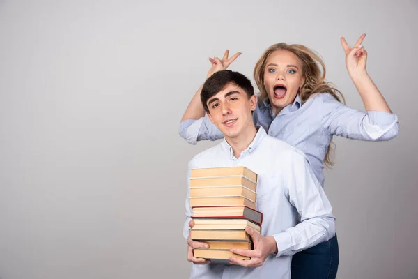 Young Lovely Couple Holding Bunch Books Posing Camera Gray Background — Stock Photo, Image