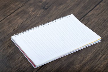 School notebook placed on a wooden background. High quality photo