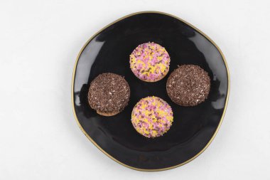 Siyah tabakta renkli şekerlemelerle dört daire şeklinde kurabiye şekerlemesi. Yüksek kalite fotoğraf