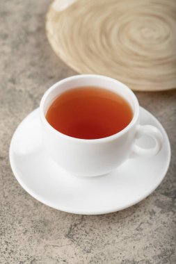 White cup of hot black tea on stone surface. High quality photo