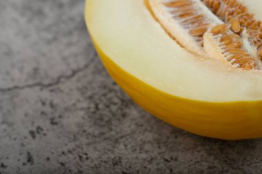 Taş zemine yarım dilimlenmiş sarı kavun yerleştirilmiş. Yüksek kalite fotoğraf