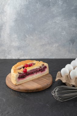 Dilimlenmiş lezzetli peynirli kek, böğürtlenli, bıyıklı ve çiğ yumurtalı. Yüksek kalite fotoğraf