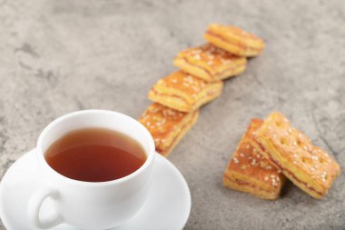 Cup of hot tea with crispy biscuits with sesame seeds. High quality photo
