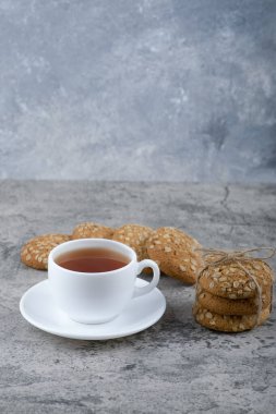 Mısır gevrekli bir yığın lezzetli kurabiye ve bir fincan beyaz çay. Yüksek kalite fotoğraf