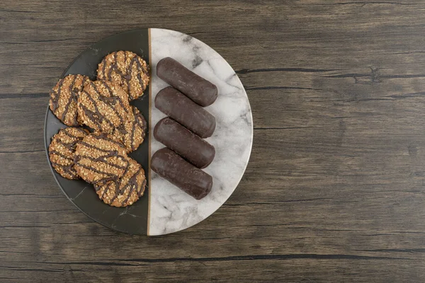 Çekirdekli kurabiyeler ve mermer tabakta çikolatalı kek. Yüksek kalite fotoğraf