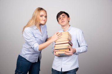 Ortağının elleriyle edebiyat kitaplarını tutan genç bir adam. Yüksek kalite fotoğraf