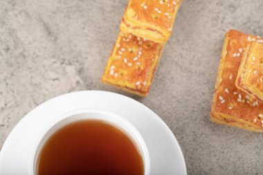 Cup of hot tea with crispy biscuits with sesame seeds. High quality photo