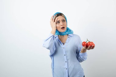 Mendilin içinde kırmızı domatesler tutan güzel bir kadın resmi. Yüksek kalite fotoğraf