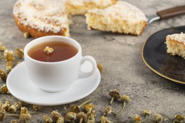 A cup of tea with dried flowers placed on stone table. High quality photo