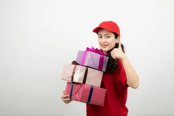 Smiling Woman Red Uniform Stack Present Boxes Showing Thumb High — Stock Photo, Image