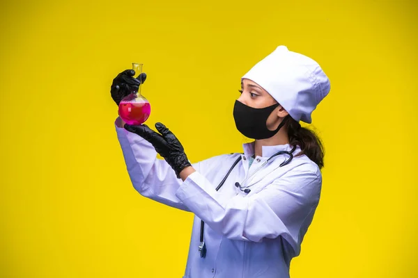 Young Nurse Face Hand Mask Holds Chemical Flask Checks High — Stock Photo, Image