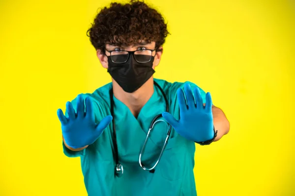 Curly Hair Boy Medical Uniform Face Mask Showing His Plastic — Stock Photo, Image