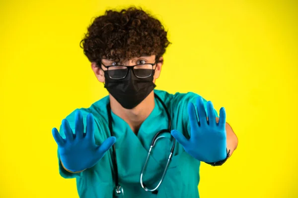 Curly Hair Boy Medical Uniform Face Mask Showing His Plastic — Stock Photo, Image