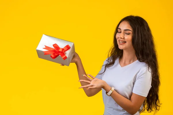 Chica Joven Posando Con Una Caja Regalo Mano Mirando Ella — Foto de Stock