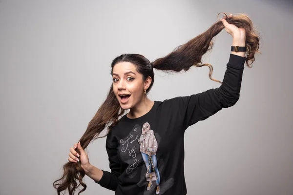 Mujer Joven Con Sudadera Casual Mostrando Sus Coletas Foto Alta — Foto de Stock