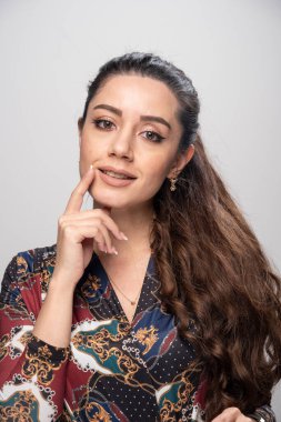 Kameraya poz veren renkli bluzlu genç bir kadın. Yüksek kalite fotoğraf