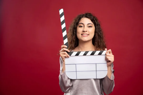 Brünette Frau Mit Klappbrett Auf Rotem Hintergrund Hochwertiges Foto — Stockfoto