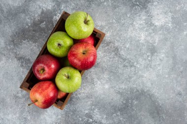 Tahta kutuya yerleştirilmiş taze yeşil ve kırmızı elmalar. Yüksek kalite fotoğraf