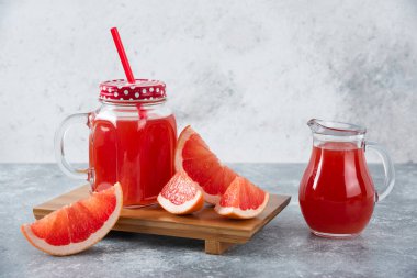 Bir sürahi taze greyfurt suyu ve bir dilim meyve. Yüksek kalite fotoğraf