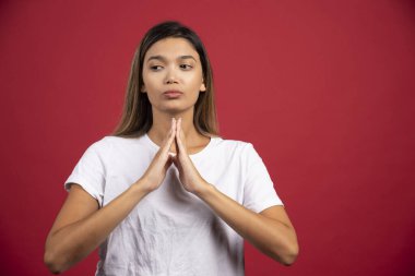 Kırmızı arka planda poz veren genç ve güzel bir kadın. Yüksek kalite fotoğraf