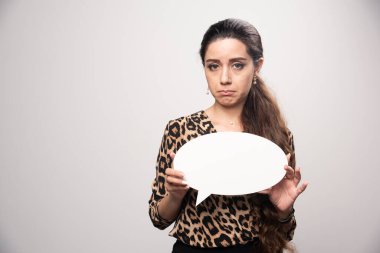 Leopar desenli tişörtlü bir iş kadını elinde ovale bir düşünme tahtası ve interaktif bir oyun oynuyor. Yüksek kalite fotoğraf