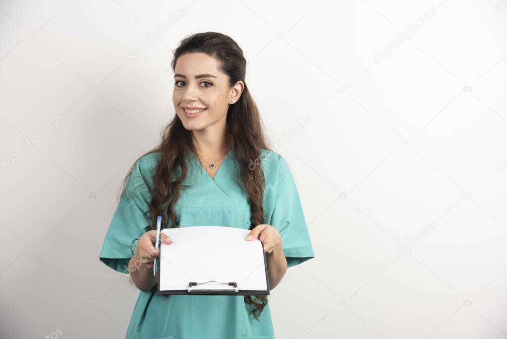 Young female medical employee holding medical records. High quality photo