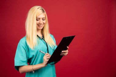 Üniformalı gülümseyen doktor panoya yazı yazıyor. Yüksek kalite fotoğraf