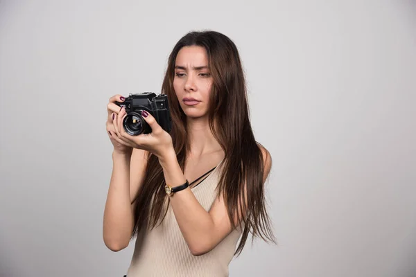 Młoda Kobieta Patrząca Kamerę Szarym Tle Wysokiej Jakości Zdjęcie — Zdjęcie stockowe