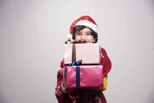 Щаслива Дитина Санта Капелюсі Тримає Різдвяні Подарунки Фотографія Високої Якості — стокове фото