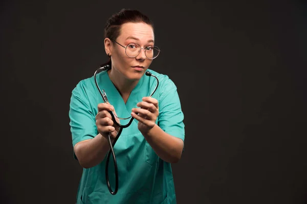 聴診器を持った緑の制服の女医と点検 高品質の写真 — ストック写真