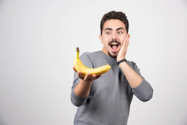 Morena Homem Olhando Para Banana Feliz Foto Alta Qualidade — Fotografia de Stock