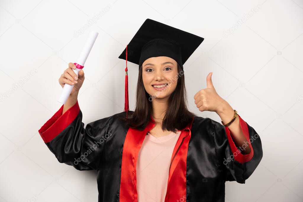 Fresh graduate female with diploma posing on white background. High quality photo