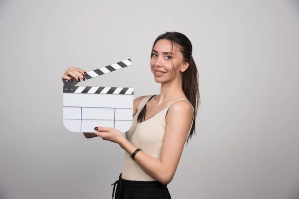 Smilende Kvinne Med Clapperboard Grå Bakgrunn Bilde Høy Kvalitet – stockfoto