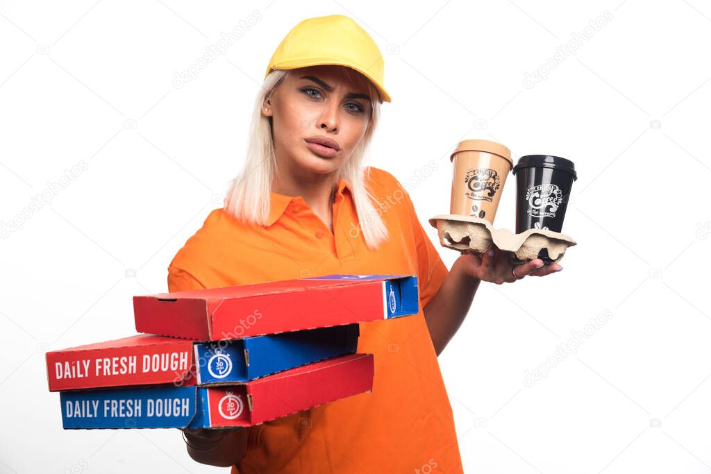 Pizza delivery woman holding pizza and coffees on white background. High quality photo
