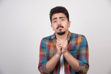 Üzgün yakışıklı adam elini çapraz yapıp bir şey istiyor. Yüksek kalite fotoğraf