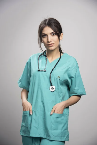 Doctora Uniforme Pie Sobre Fondo Gris Foto Alta Calidad — Foto de Stock