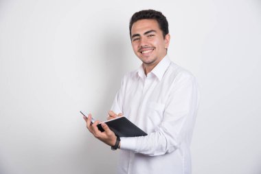 Beyaz arka planda duran gülümseyen bir iş adamı. Yüksek kalite fotoğraf