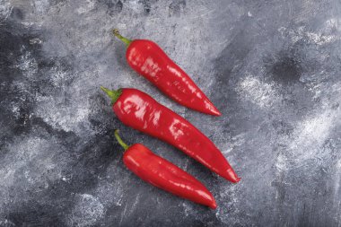 Red fresh chili peppers placed on marble surface. High quality photo