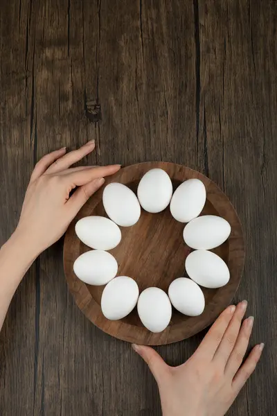 Vrouwelijke Handen Met Houten Plank Met Rauwe Eieren Houten Ondergrond — Stockfoto