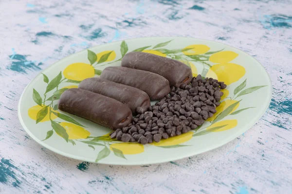 Plate of chocolate bar cakes with drop chocolates on marble background. High quality photo