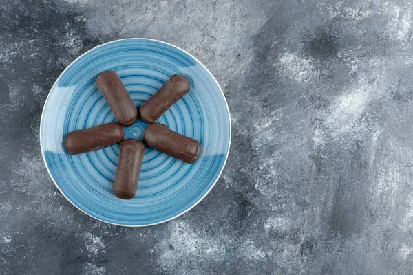 Mermer arka planda mavi çikolata kremalı rulo. Yüksek kalite fotoğraf