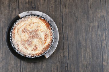 Tahta masaya konmuş şekerli bir tabak lezzetli turta. Yüksek kalite fotoğraf