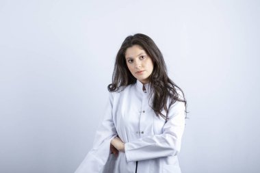 Photo of young doctor posing and standing on white background. High quality photo