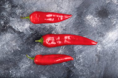 Red fresh chili peppers placed on marble surface. High quality photo